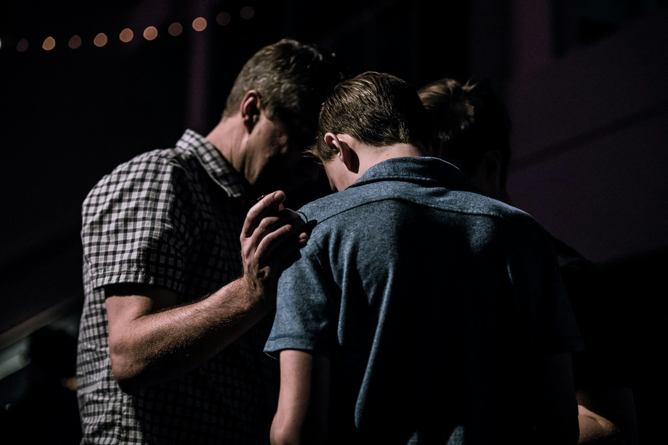 Men praying together in fellowship at 18:16 Ministries